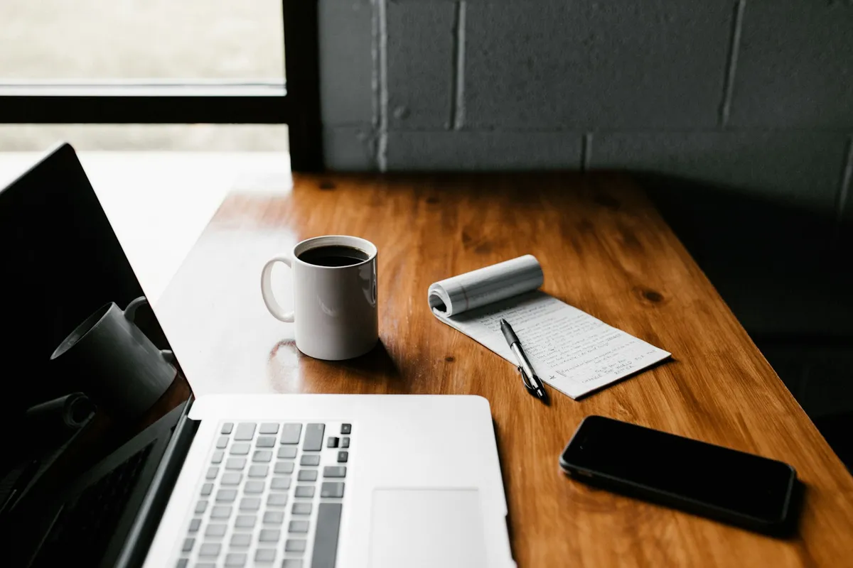 Laptop and coffee on a wood desk